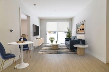A living room with a couch and a table and a tv